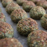 Backed falafel balls on a backing tray set in rows